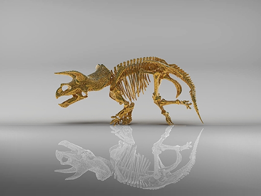 golden 3D-printed skeleton of triceratops with white reflection