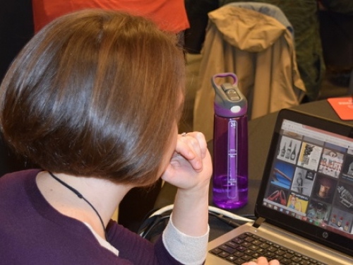 Teacher looking at computer screen.