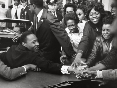 Martin Luther King Jr. surrounded by supporters